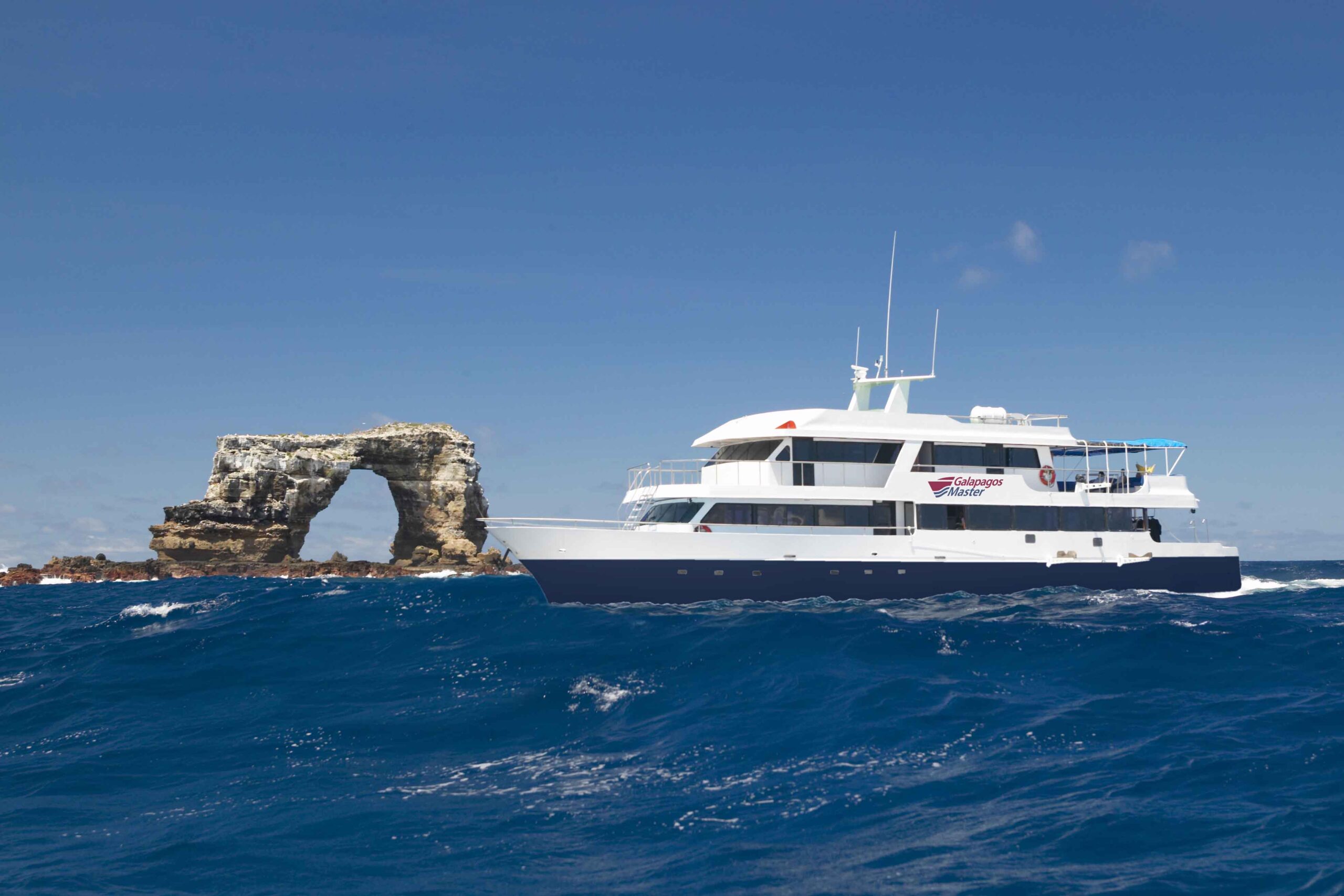 galapagos yacht next to a rock formation