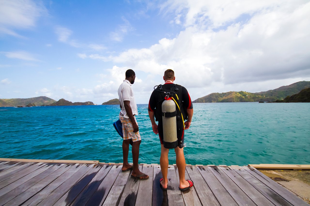 A crew member and a diver getting ready to dive