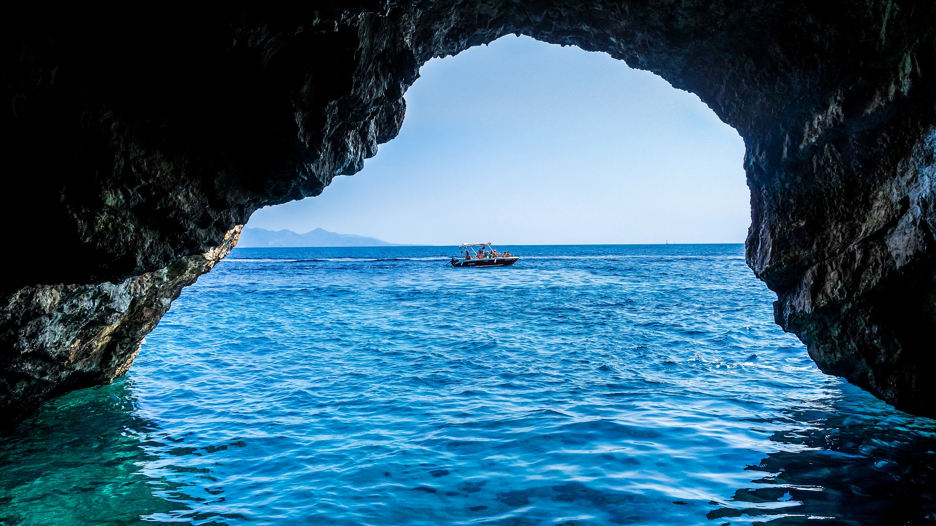 a speedboat shot through a cave entrance